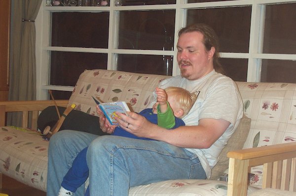 Tim reading with Daddy (8-7-2004 20:30)