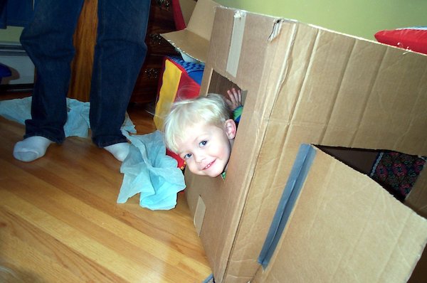 Tim looking out the cardboard house window (03-19-2005 15:21)