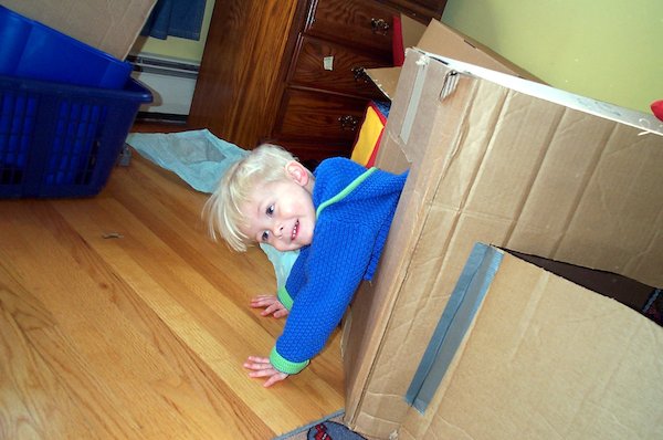 Tim climbing out the window of the cardboard house (03-19-2005 15:22)