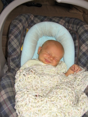 Cole in Manbasket napping (smiling) (06-30-2005 17:58)