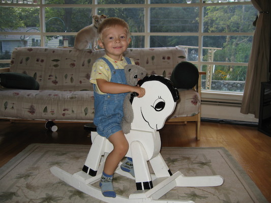 Tim and bear on rocking horse (and Emily) (09-04-2005 09:42)