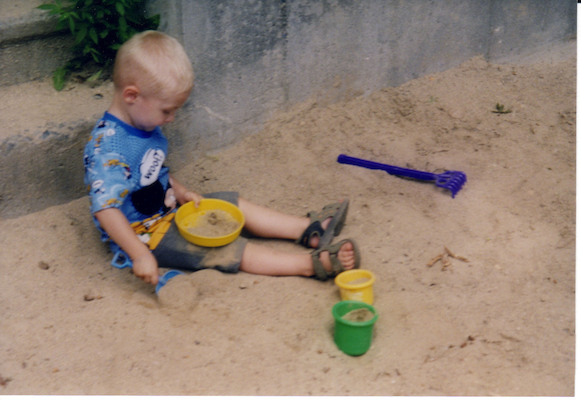 Tim playing in sand