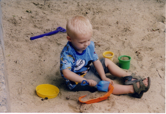 Tim playing in sand